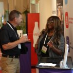 CEA Staffing ambassador Keyanna laughing while talking with an attendee at an education conference in San Antonio