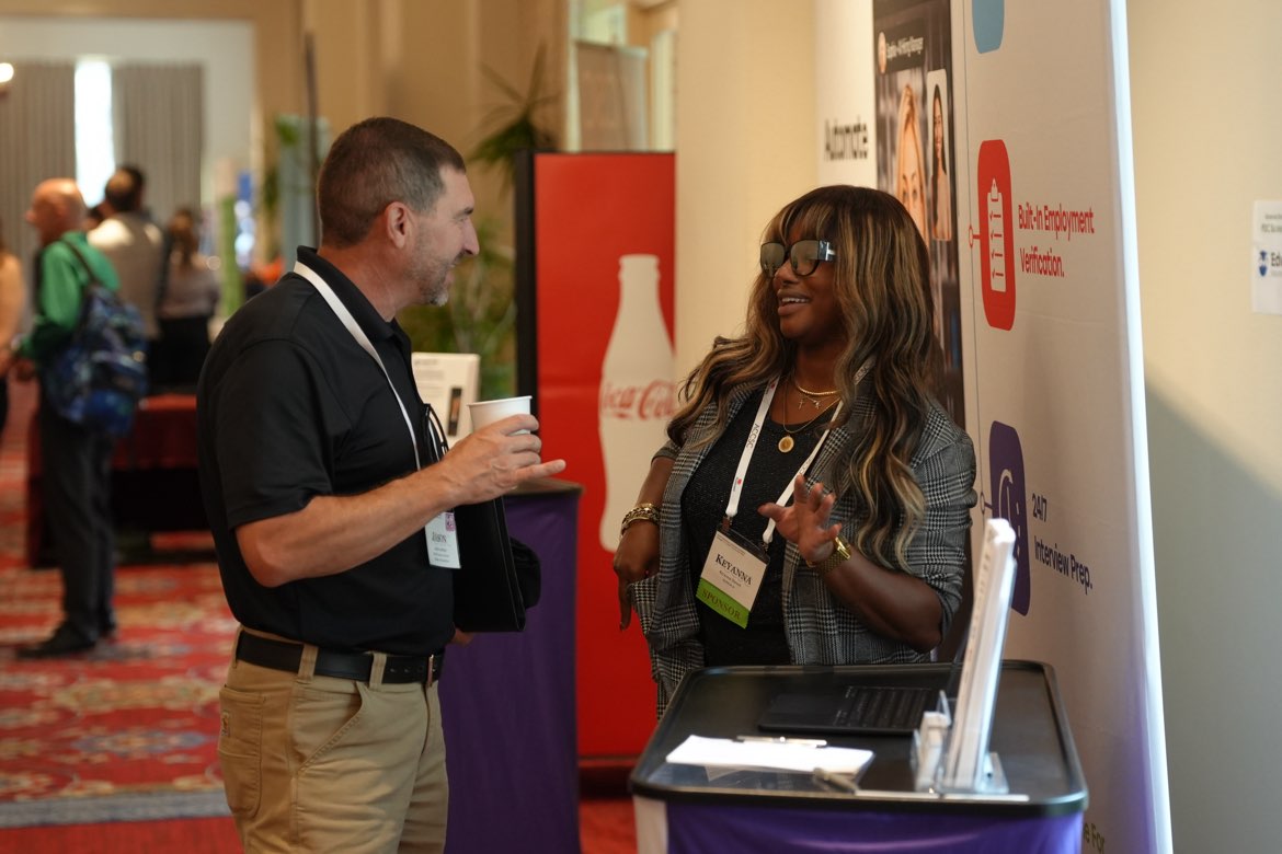 CEA Staffing ambassador Keyanna laughing while talking with an attendee at an education conference in San Antonio